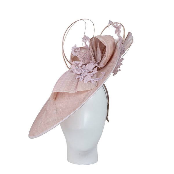 Pink decorative hat on a mannequin head against a white background