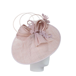 designer hats - a pink decorative hat on a mannequin head against a white background