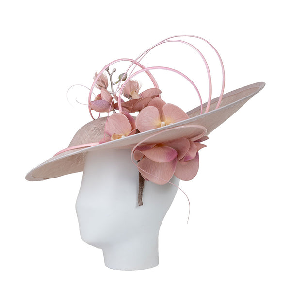 Pink floral hat on a mannequin head against a white background