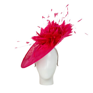 hot pink derby hat adorned with feathers on a mannequin head against a white background