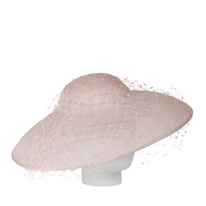Beige wide-brimmed hat on a mannequin head against a white background