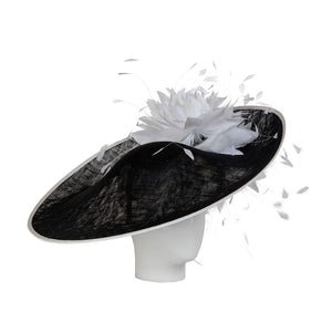 A luxury ladies derby hat in black and white, adorned with feathers.