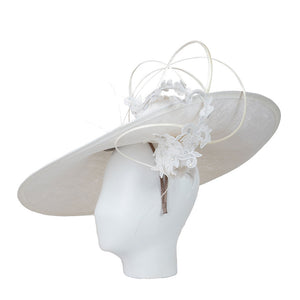 White wide-brimmed hat with floral details on a mannequin head against a white background