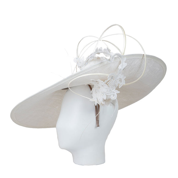 White wide-brimmed hat with floral details on a mannequin head against a white background