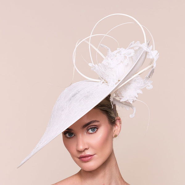 Ladies high end hat. Woman wearing a white decorative hat against a beige background