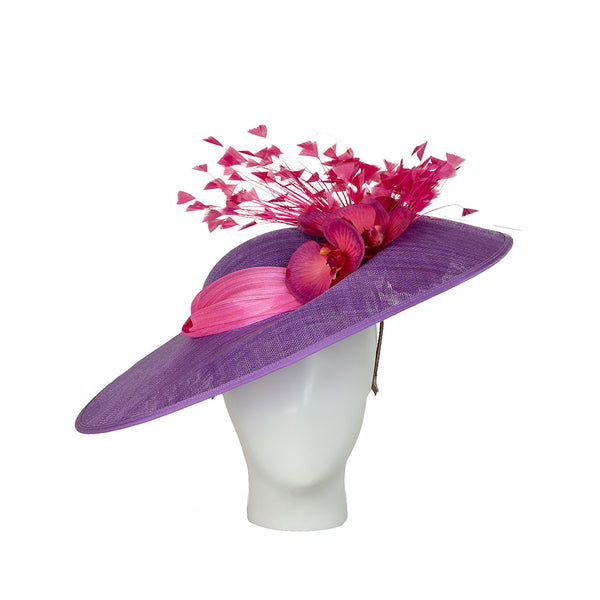 Purple and pink derby day hat on a mannequin head against a white background